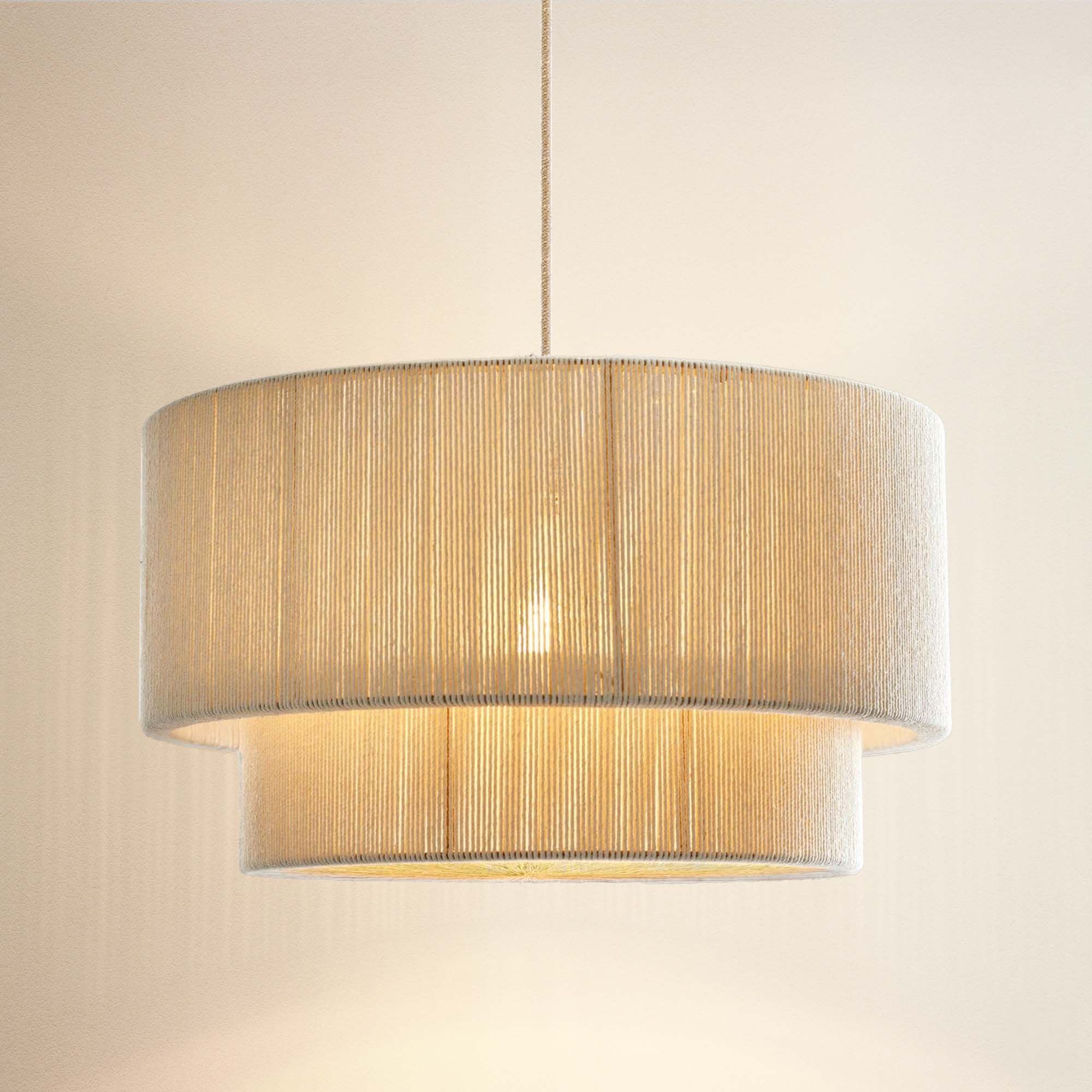elaine beige rattan rendant light with a cylindrical shade, on