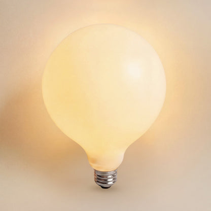 2700k rowabi light bulb white glass e26 base emitting a warm glow