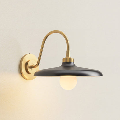 arcoris metal sconce wall-mounted light fixture with black shade and gold arm, on