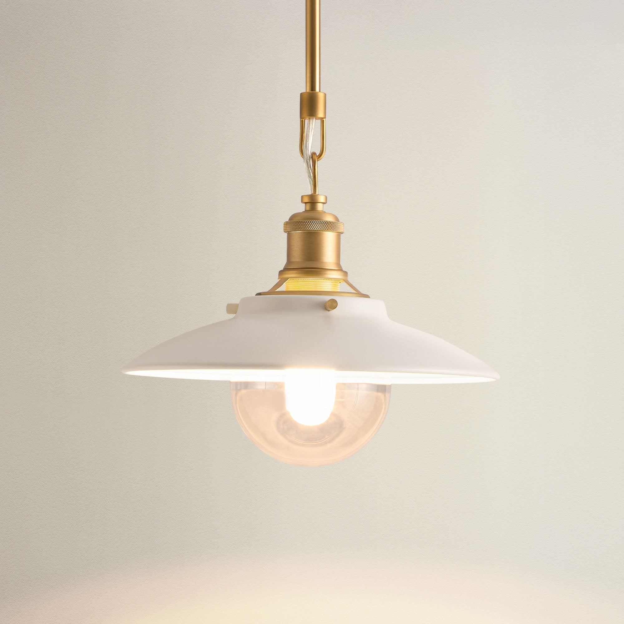 lanesra glass pendant light with white shade and brass fixture, on