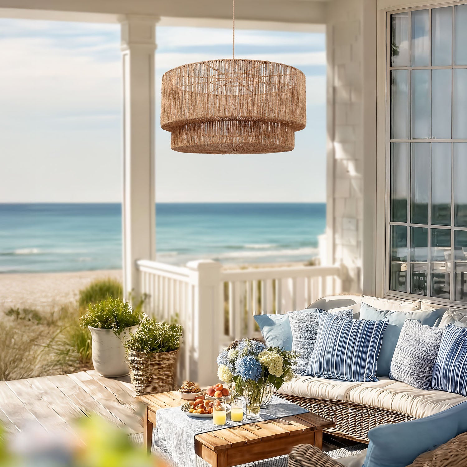 outdoor luminous pendant light living space with ocean view and wicker furniture